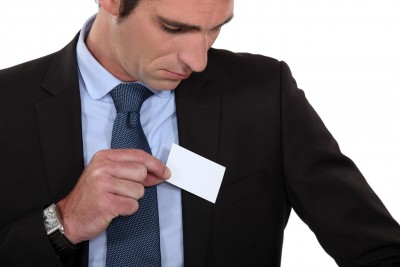 Man putting business card in pocket networking